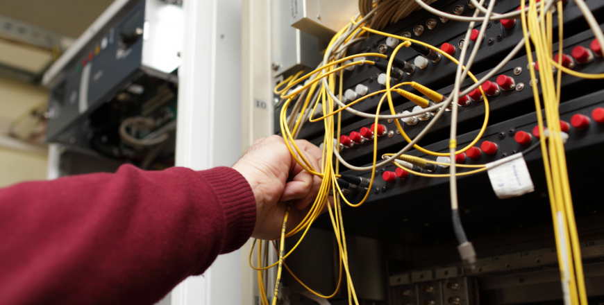 Fibre optic technician configuring fibre optic on ODF at telecom site