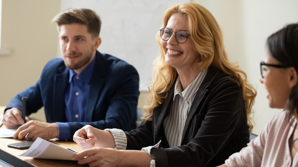 Business executives engaged in executive coaching at a conference table