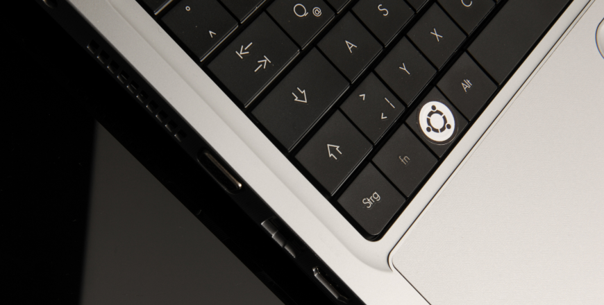 Computer with Ubuntu software logo on keyboard