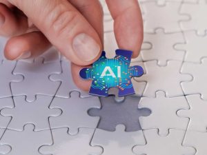 A hand places the last piece of the puzzle piece labelled AI