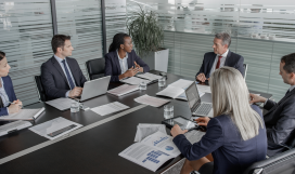 A group of telecom executives and business analysts in a project management meeting to find solutions