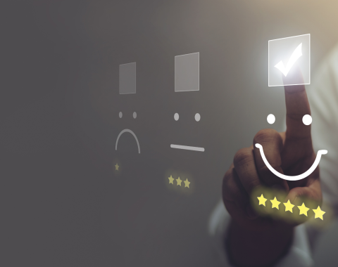 Telecom customer pressing smiley face emoticon on virtual touch screen to indicate customer satisfaction and evaluate service