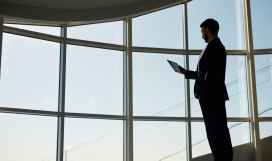 Businessman with touchpad networking inside business building