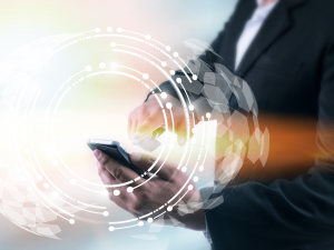 Man in suit using mobile phone with wireless mobile technology