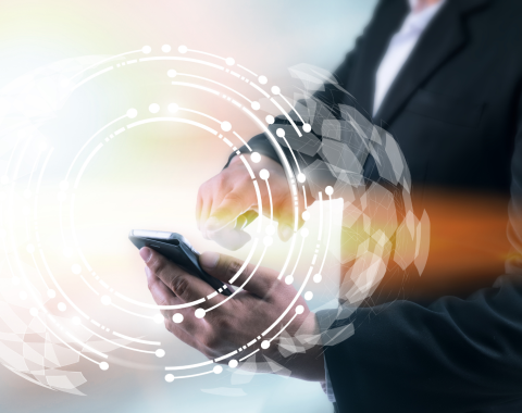 Man in suit using mobile phone with wireless mobile technology