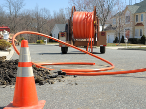 Conduit roll for laying fiber optic lines in residential estate