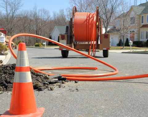Conduit roll for laying fiber optic lines in residential estate