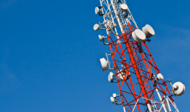 Radio transmission tower against sky background