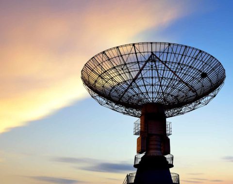 Satellite dish against sunset skies