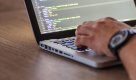 Software developer implementing DevOps using laptop in the office