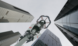 5G transmission tower in downtown with corporate buildings