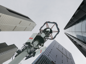 5G transmission tower in downtown with corporate buildings