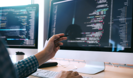 Software radio engineer points to computer screen using pen and analyzes the code