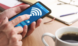 Hands touching screen of smartphone to set up WiFi