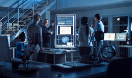 Project manager leads meeting with a team of electronic development engineers using a digital whiteboard explaining neural network technology, AI and machine learning