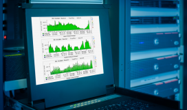 Monitor showing graph information of network traffic and wireless status of device in server room data centre